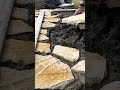 arranging natural stone slabs over fresh cement mortar base to create durable paving patterns