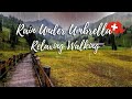 Walking in the Swiss Mountains in the Rain with Umbrella Villages of Switzerland