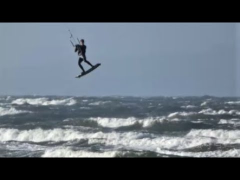 Ace kite surfers leap in the air plus some slow motion stunt action. Barassie beach, Scotland.