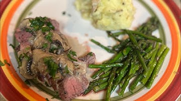 Filet mignon with a mushroom cream sauce and asparagus with creamy mashed potatoes