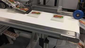 Feeding zippered bags, labeling top and bottom