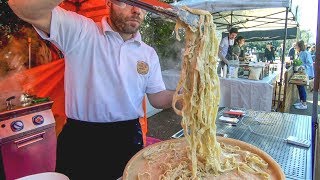 Italian Pasta and LOT of Cheese. Pasta in a Cheese Wheel. London Street Food