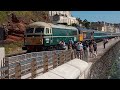 Trains.  Double headed Class 69's haul a Pathfinder charter along the Dawlish Sea Wall.