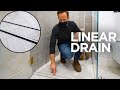 Looking at linear drain and built-in dresser with hidden bifold door | Site Visit