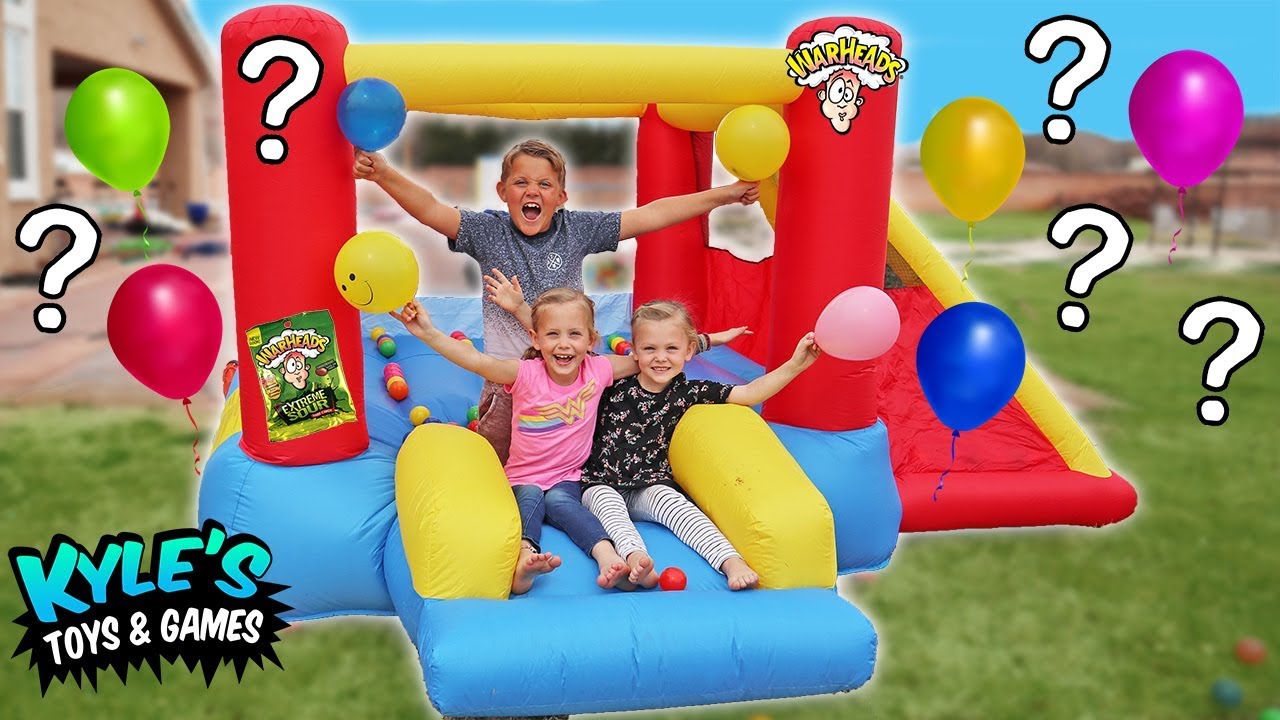 KID'S SOUR CANDY Balloon POP Challenge Inside GIANT Inflatable Water Slide! Warheads and Toxic Waste