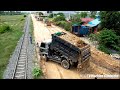 Best operator skills dozer and truck spreading stone making foundation cement road in rainy season