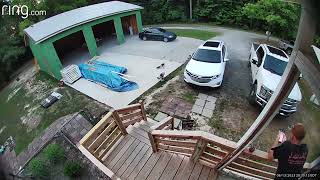Boy rides tricycle off ledge near driveway the faceplants onto dirt (Security camera)