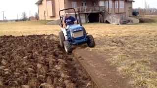 Ford-New Holland 1320 4wd tractor pulling custom made single bottom plow