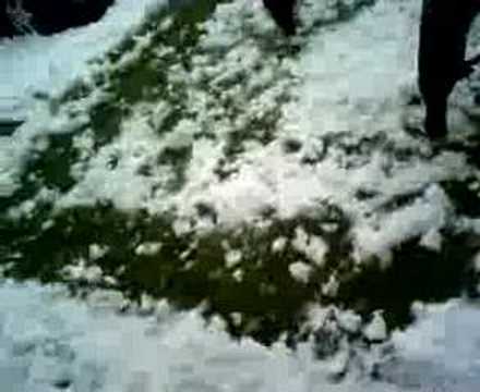 SHOVEL OF SNOW LANDS ON KIDS HEAD