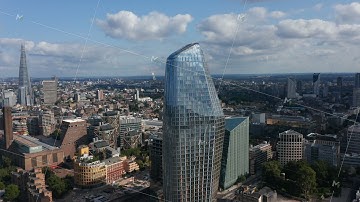 Ascending footage of One Blackfriars tall modern building with shiny glass facade. The Shard