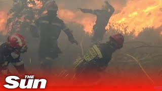Firefighters run for their lives as wildfires engulf them in Spain