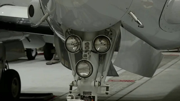 Crewmaster working on a C 12 Huron and a C 12 Huron taking off