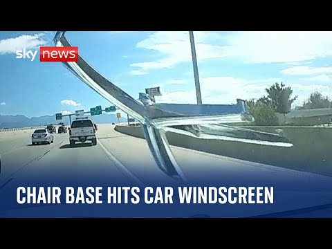 Chair base smashes into moving car's windscreen on US highway