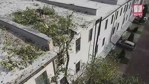 Drone Video: Tree punctures roof of condo building in Roswell during Zeta