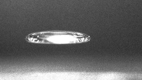 Changing the shape of an acoustically levitated drop