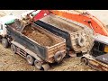 Dirt moving machinery Red Monster HITACHI Excavator and Hyundai dump truck