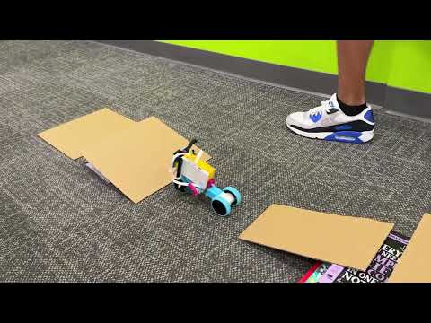 Custom Bike coded in Python being tested on an obstacle course in Python Lego Robotics Summer Camp