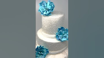 How to add texture to a fake cake and decorate with a gum paste flowers.