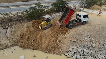 Nice Showing Land Filling Up with Talented Skills Driver Dozer Pushing Soil and Truck Unloading Soil