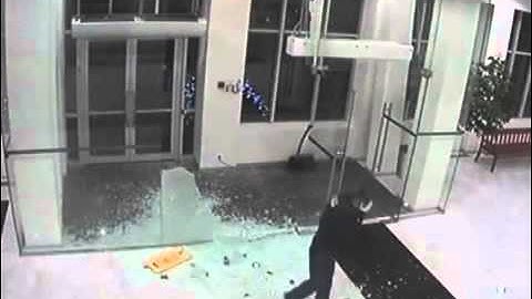 Man Walks Through Glass Entrance