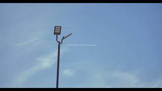 street lamp against clear blue sky with soft clouds | Cinematic 4K B-Roll screenshot 5