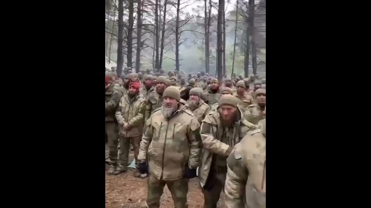 Chechen Battalion Soldiers Praying Together In The Ukrainian Forest 