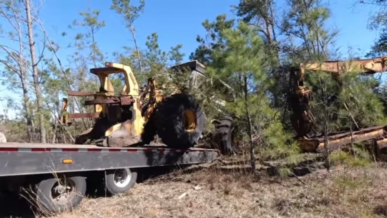 Huge winch pulls Left Behind Equipment Out of the Woods! - YouTube