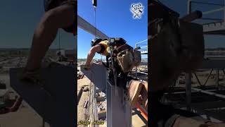 Workers are tightening bolts for the steel structure installation at a height