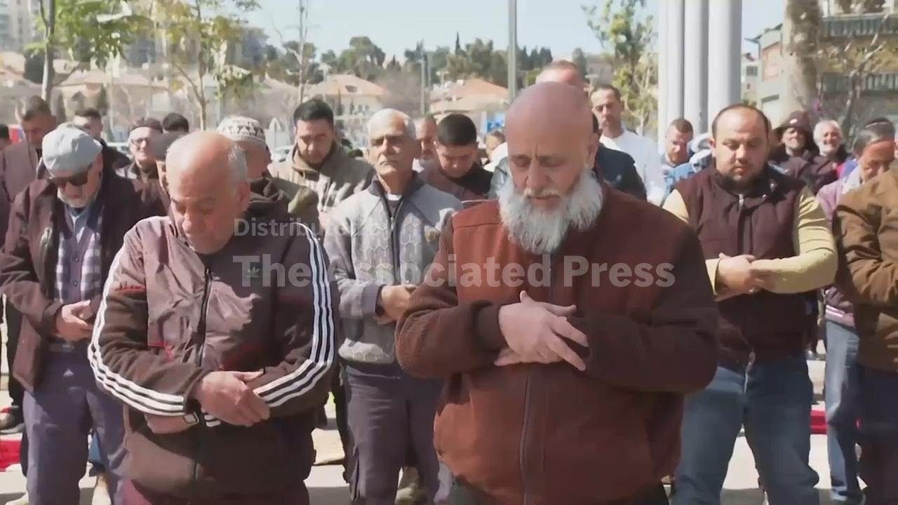 Dozens of Muslims pray outside Jerusalem's Old City, as Israeli authorities close holy sites