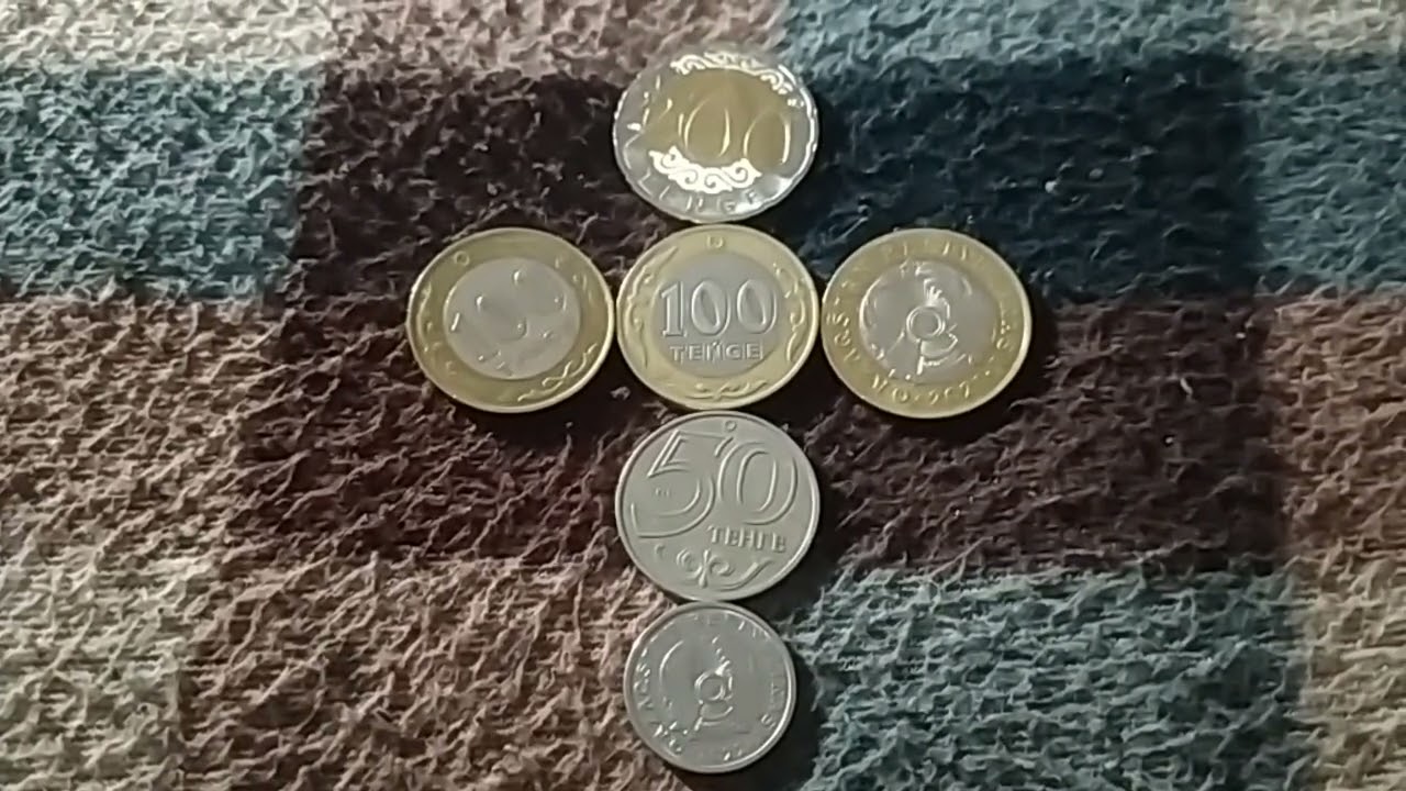 МОНЕТЫ: 1 по 200, 3 по 100, 1 по 50 и 1 по 20 ТЕНГЕ лежат на байковой поверх 11 Января Широкоформат