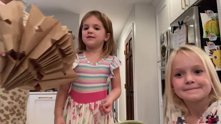 Vivian and Colette make paper bag snowflakes 2020