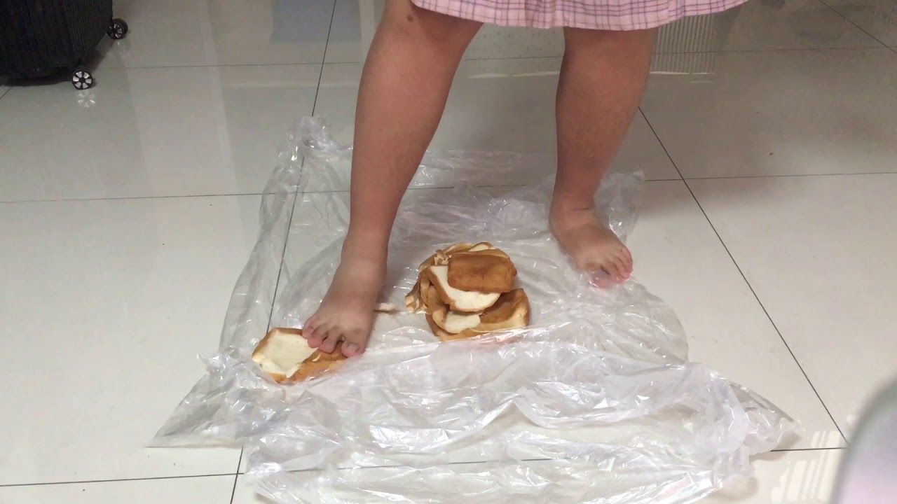 Barefoot boy crush more bread