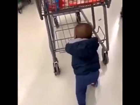 baby pushing shopping cart