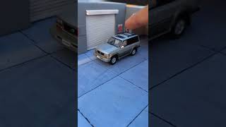 Lexus LX450 1/64 scale diecast car model by GCD at garage diorama.