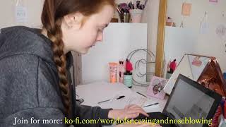 Girl sneezing while studying