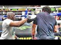Floyd Mayweather teaches the shoulder roll to a gym guest