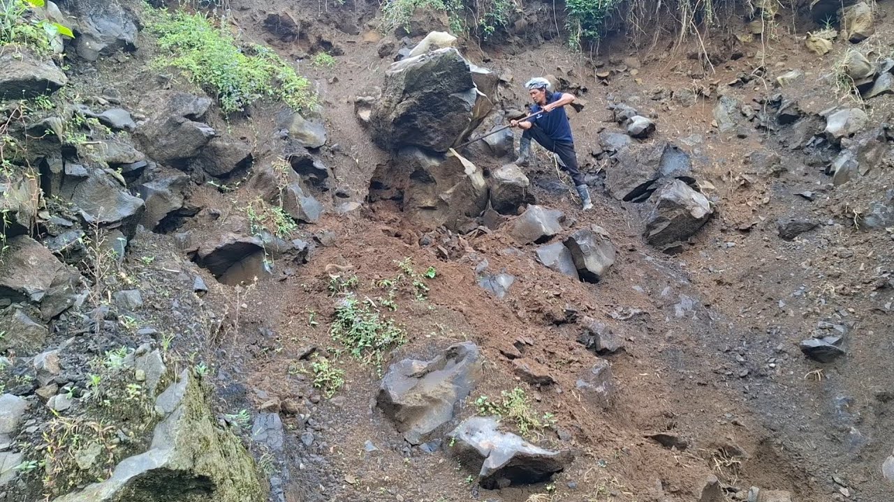 Rockman in action dropping large cracked rocks
