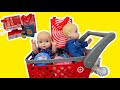 Perfectly cute baby doll Twins go shopping at Target store