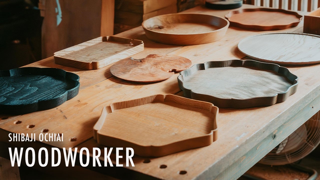 A woodworker carving trays from unknown native woods, revealing