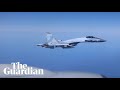 Russian jet filmed flying within metres of RAF spy plane
