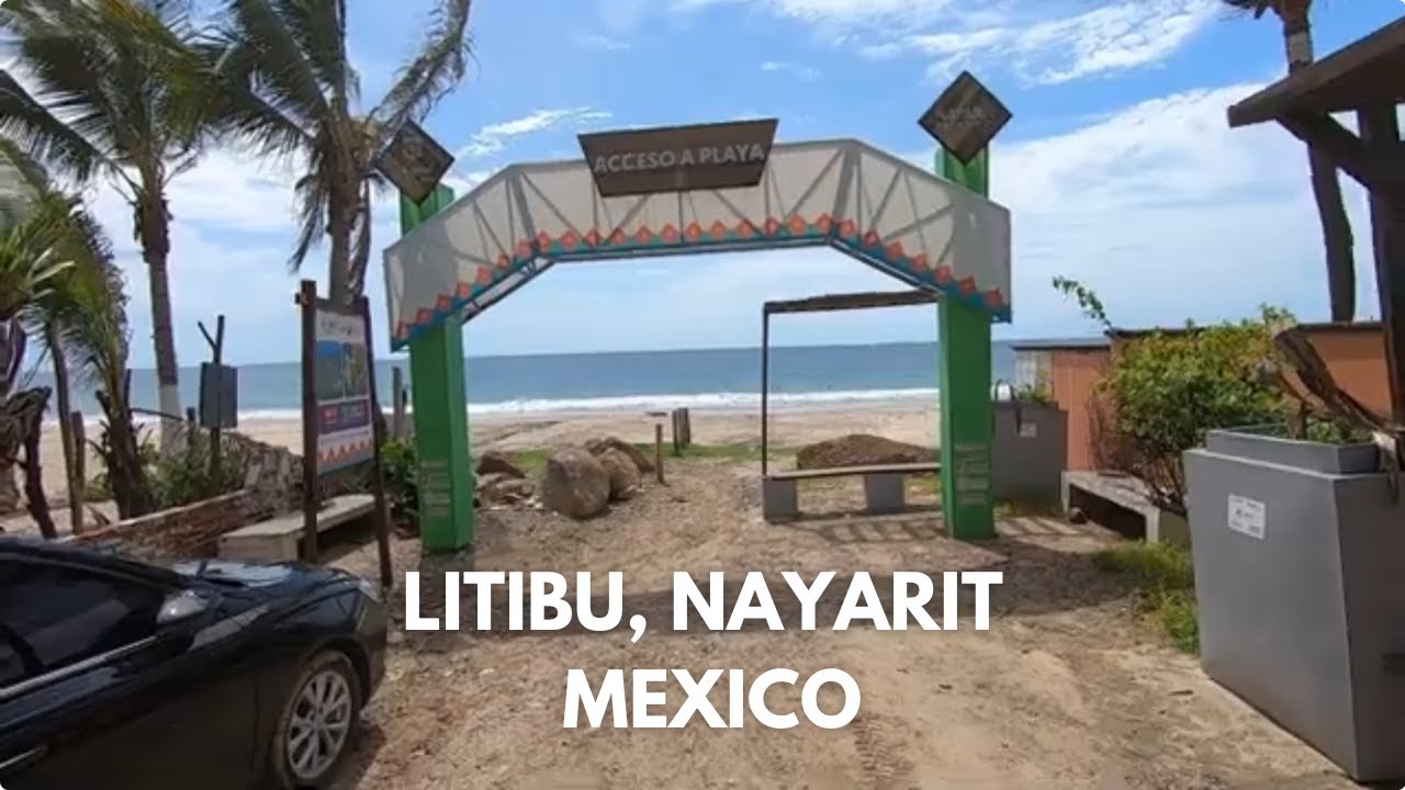 Golden sand beach at Playa Litibú in Riviera Nayarit, Mexico with calm waters and palm trees