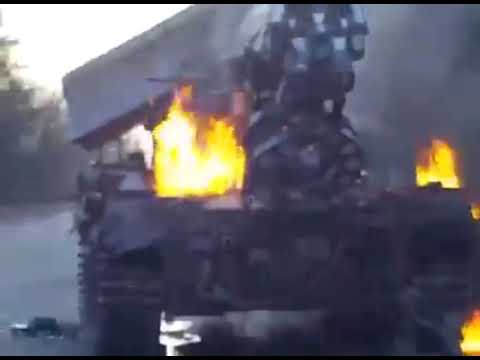 Civilian men beat Russian tankers and set fire to a Russian tank