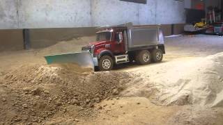 My Mack dump truck pushing dirt with a snow plow blade.