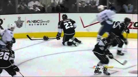 Henrik Sedin backhands Dustin Brown and puts him down