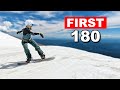 Teaching snowboarder first frontside 180 on a jump