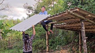 The homeless girl and Mr. Khang quickly finished the roof of the pigsty before it rained.