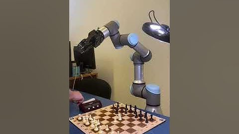 UR3e robot arm playing chess against human player
