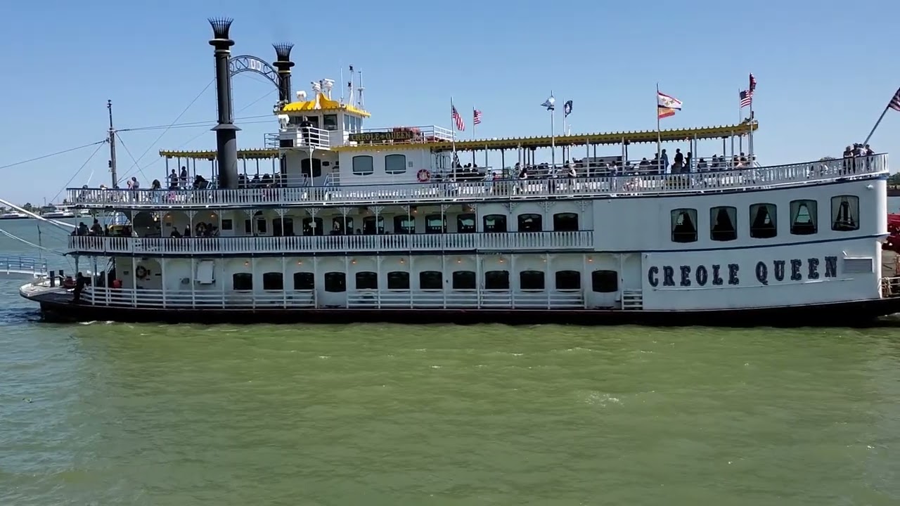 Paddlewheeler Creole Queen Docks After Large Ship Passes by on Mississippi River