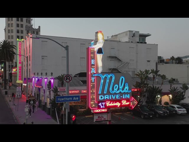 Neon Nights at Mel's Diner: Iconic Hollywood Eatery | Stunning Drone Footage | B-roll exterior (4k) class=