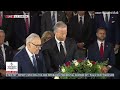 WATCH: The Emotional Ceremony Continues with Singing and Wreaths Surrounding the Casket - 07/28/26
